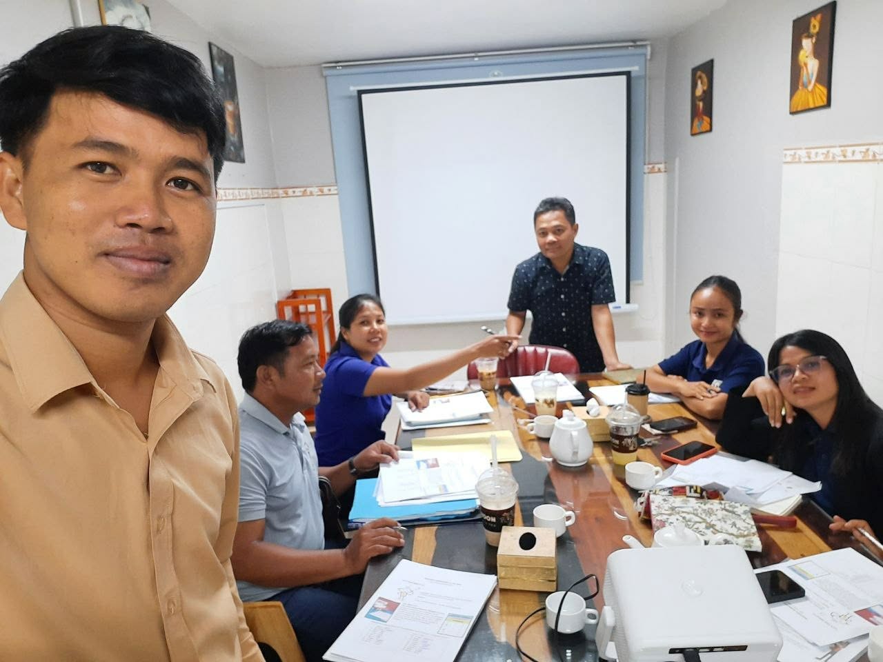 NFO teachers and management in a training session with projector and printed materials