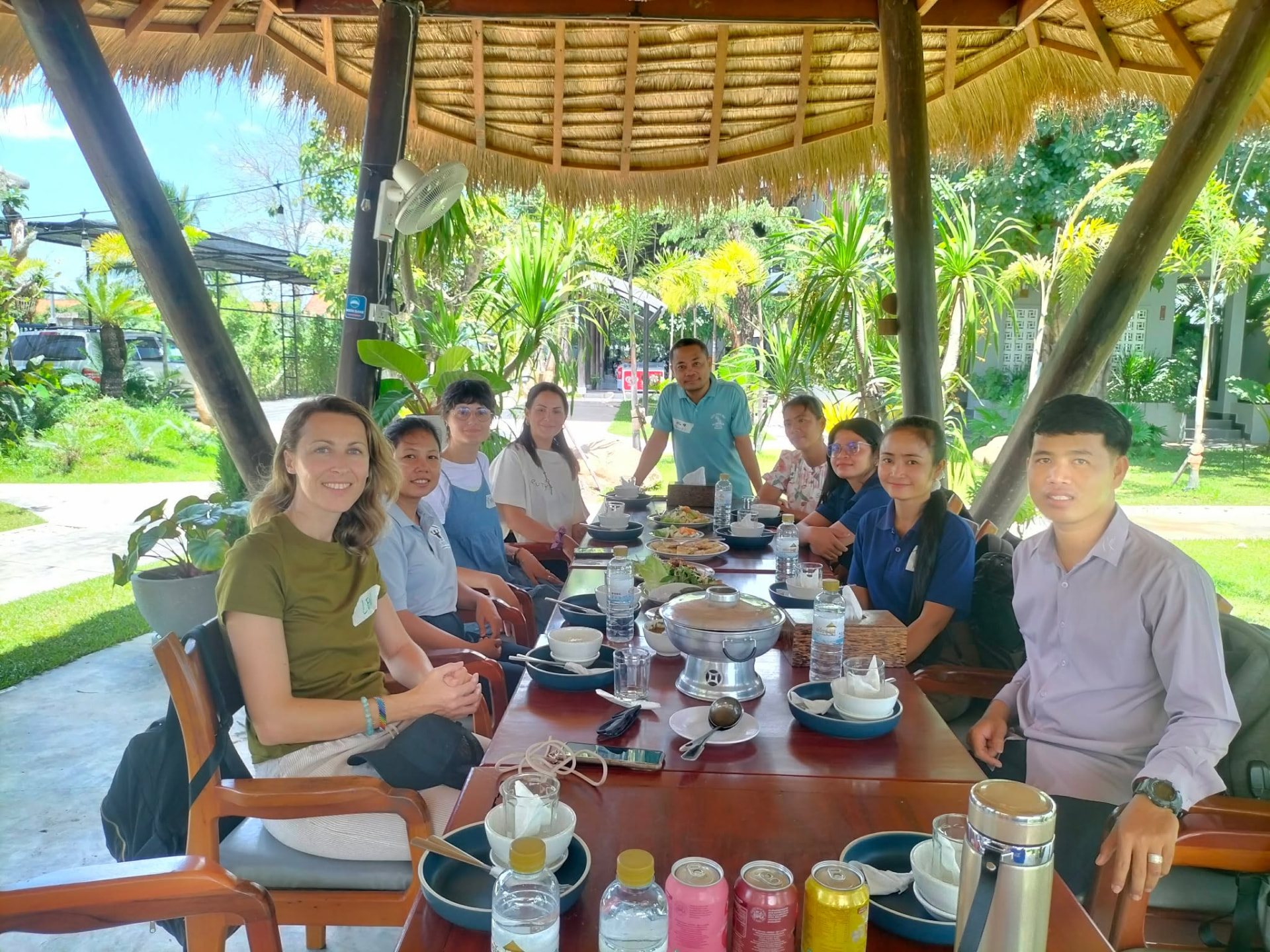 NFO staff and international trainers sitting together at a long table after a training day
